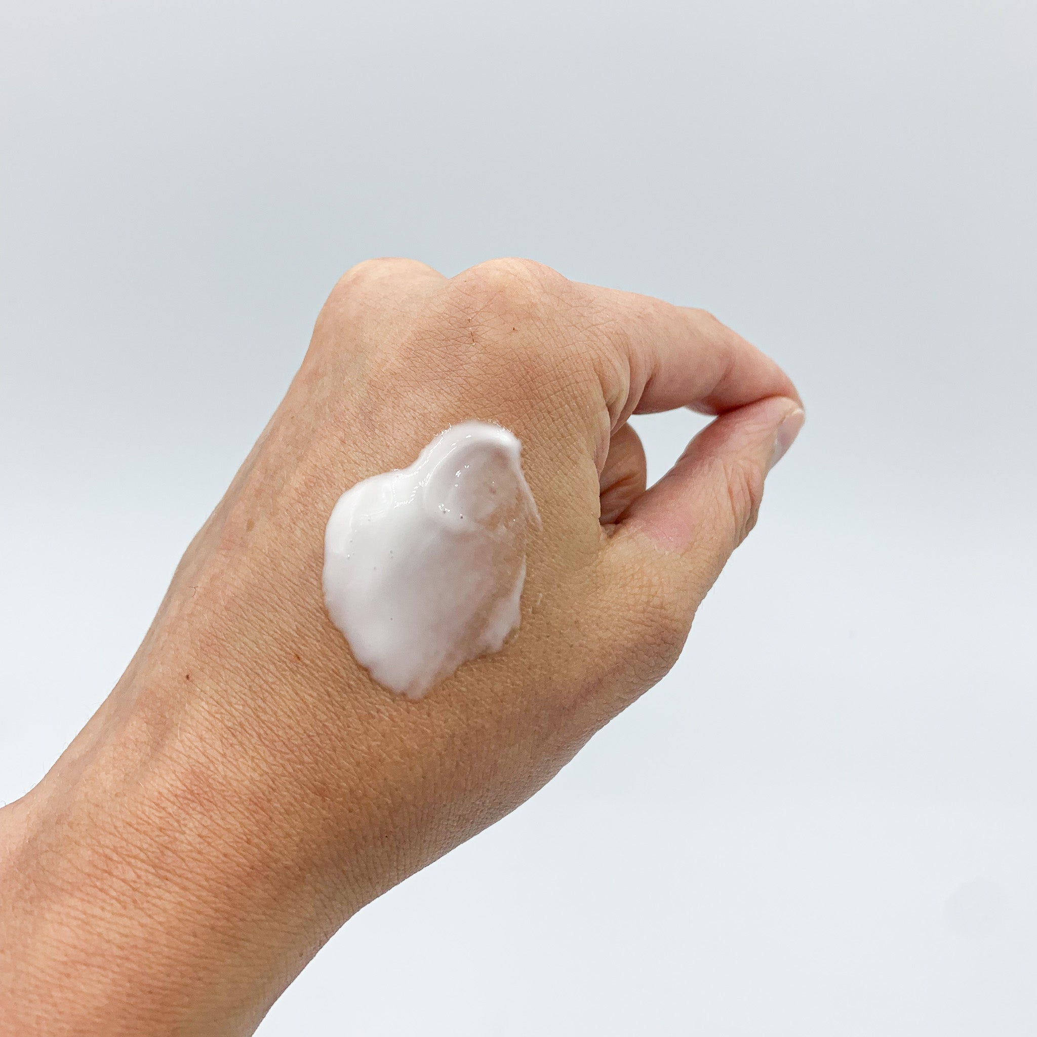 Non-greasy and fast absorbing vanilla and coconut body lotion smeared on hand.
